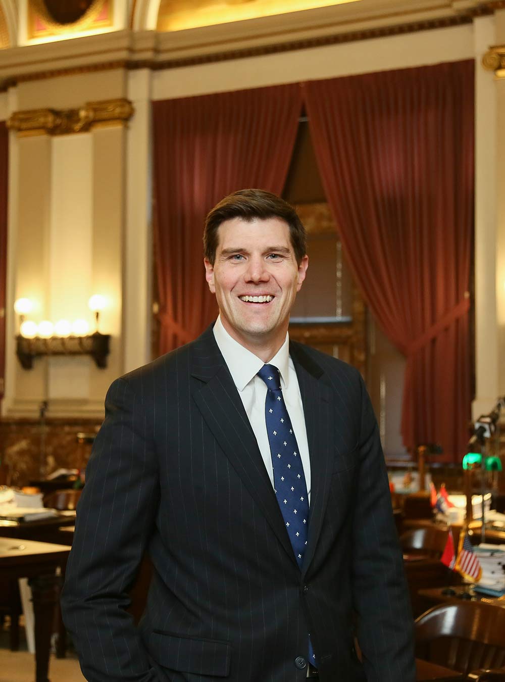 Alderman Tom Oldenburg smiling in the chambers