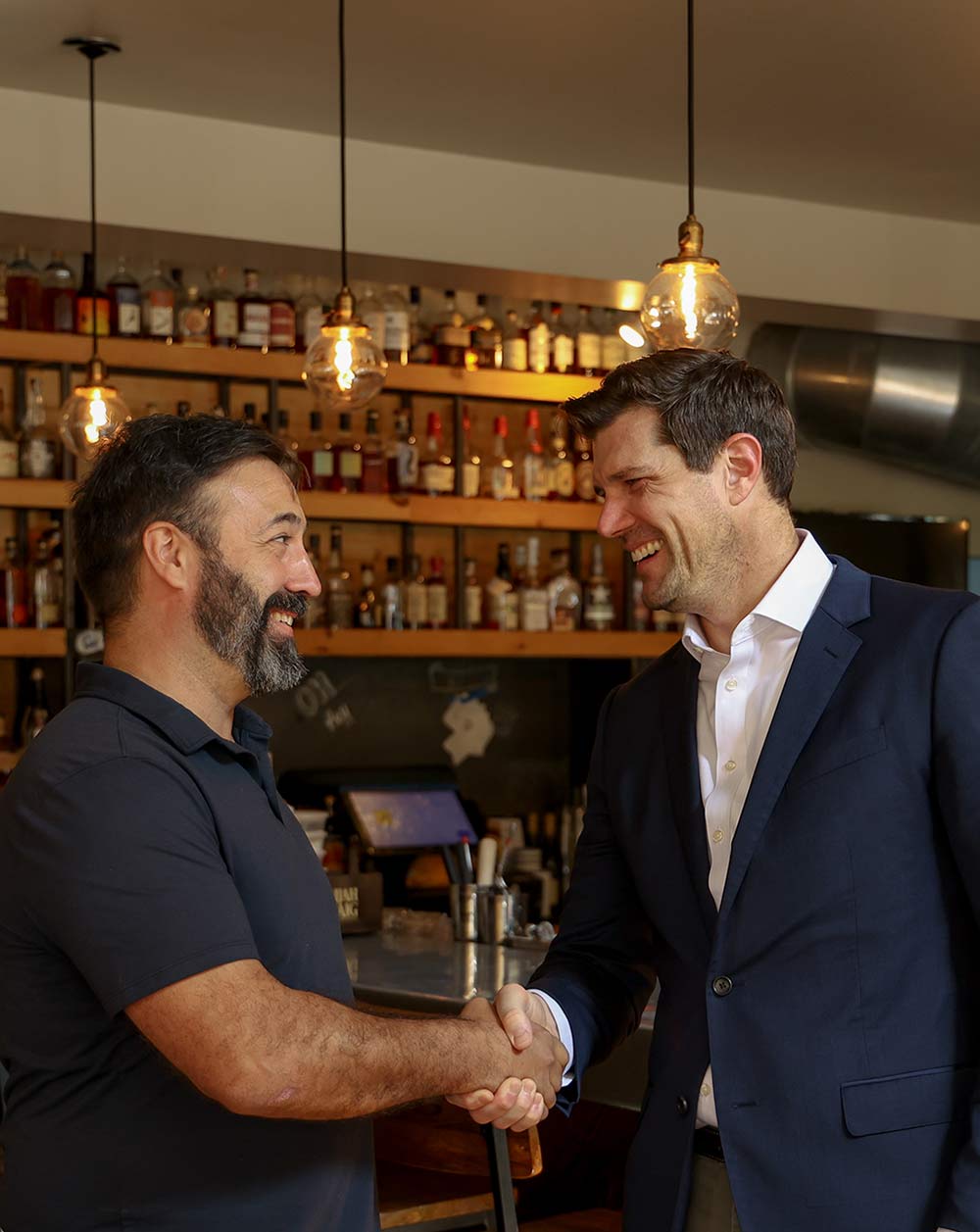 Tom Oldenburg shaking hands with St. Louis business owner